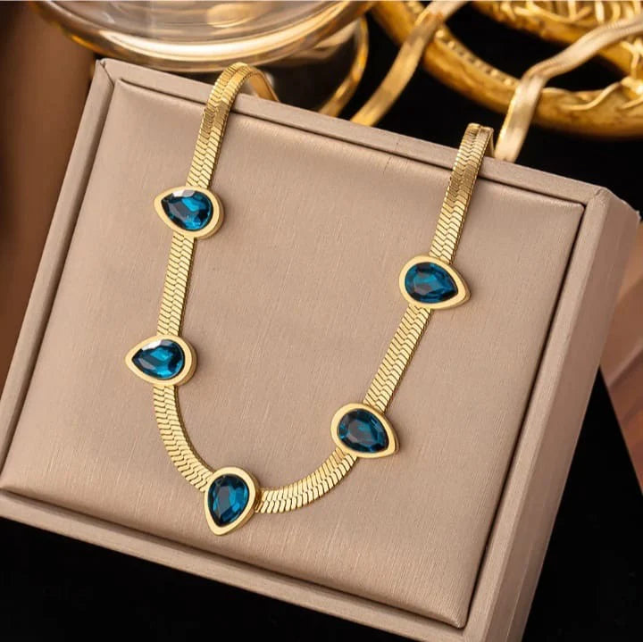 Gold Herringbone Necklace with Blue Teardrop Gem Accents