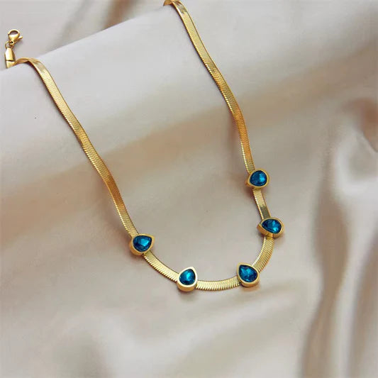 Gold Herringbone Necklace with Blue Teardrop Gem Accents